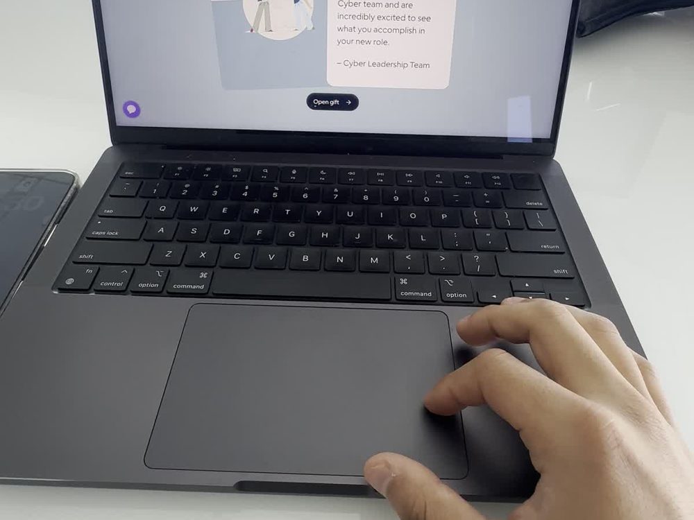 Hands on a laptop keyboard, code on the screen.